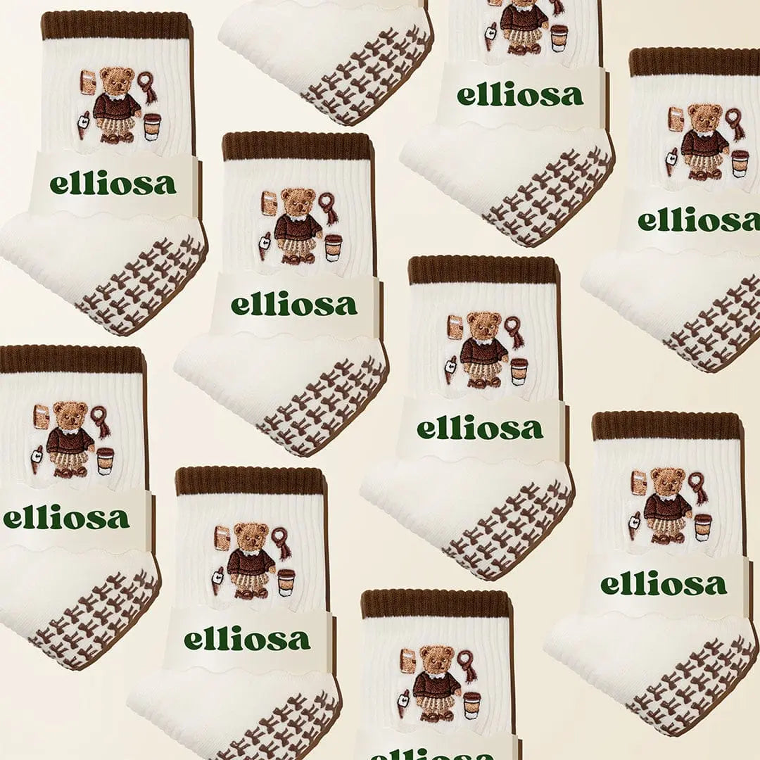 Pattern of socks with teddy bear design and 'elliosa' branding on a beige background