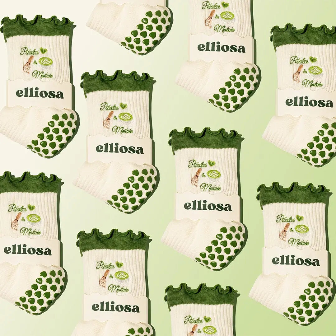 Collage of white and green socks with 'elliossa' branding on the packaging, with the words 'pilates & matcha' embroidered around images of matcha. There are green heart shaped grips on the soles.