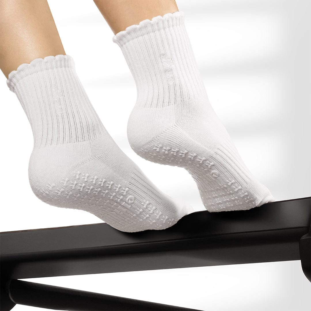 White socks with textured sole on a white background