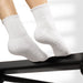 White socks with textured sole on a white background