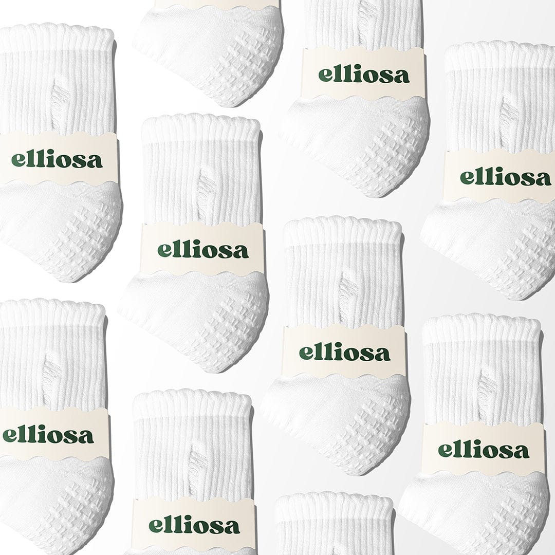 Multiple pairs of white socks with 'elliosa' branding on a light background