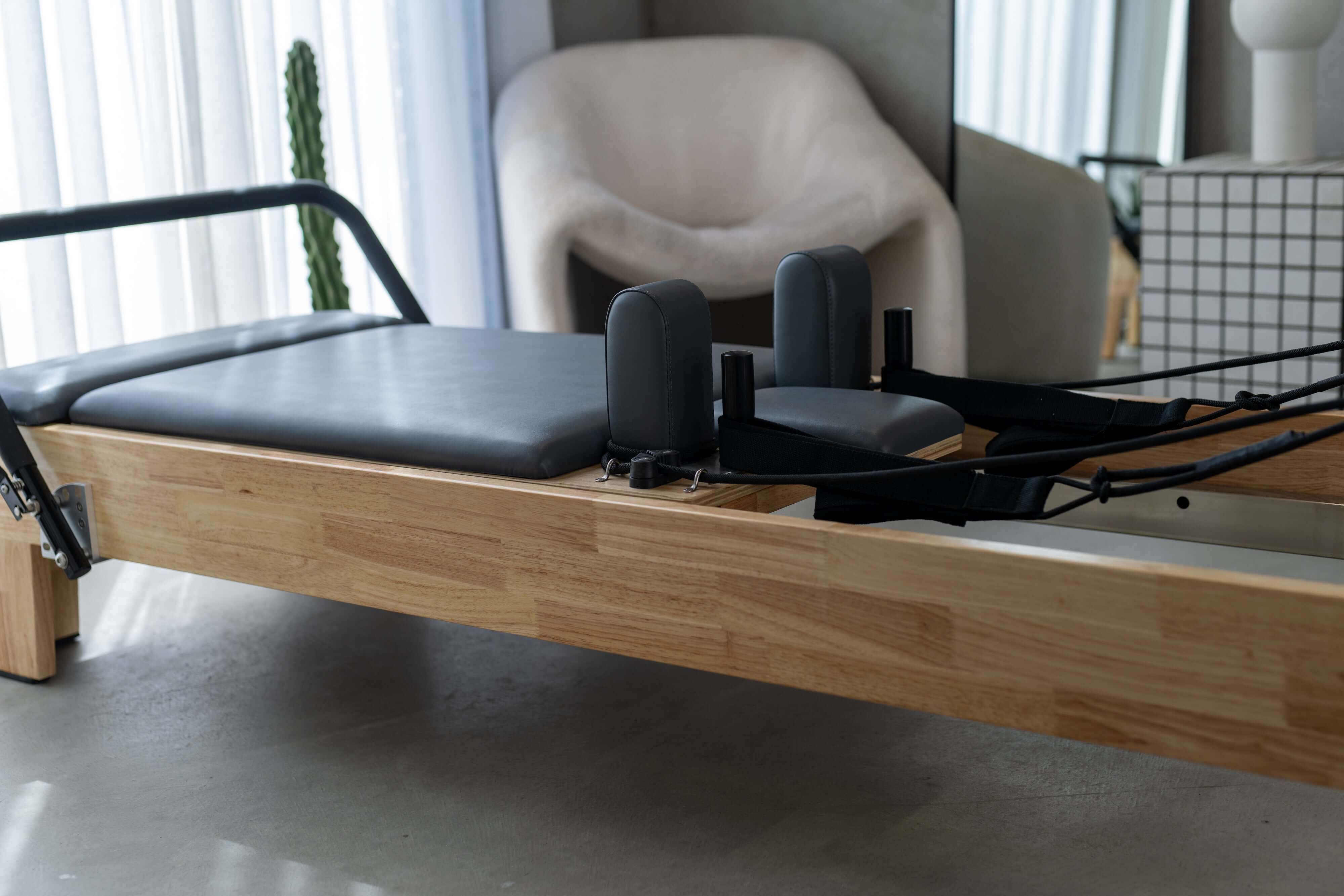 Close up of the Core Collab Eco Warrior Pilates Reformer Beechwood frame.