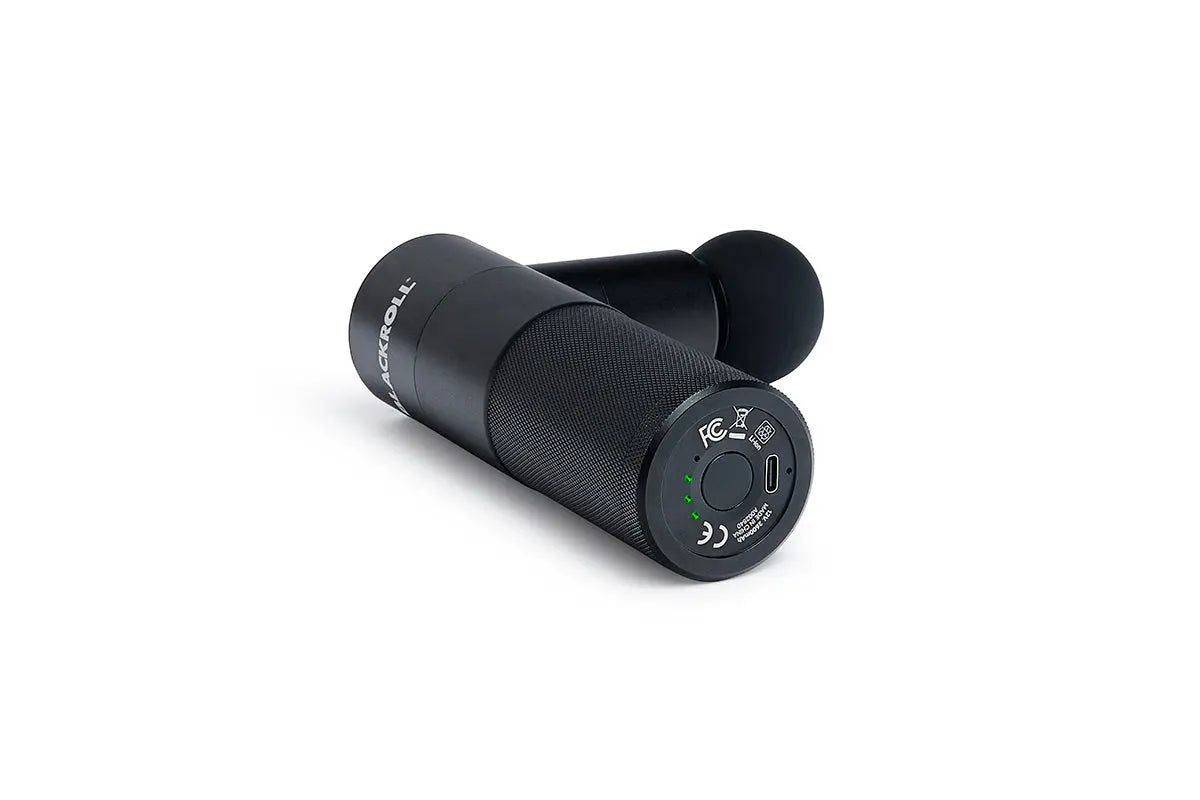 Bottom view of the Blackroll fascia massage gun showing the power button, battery lights and the charging point.