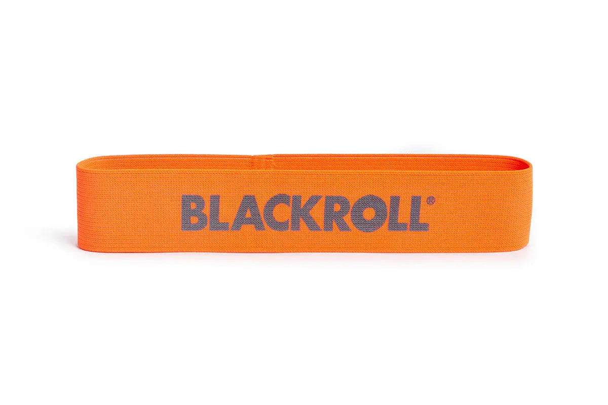 An orange blackroll loop resistance band on it's side with blackroll logo visible.