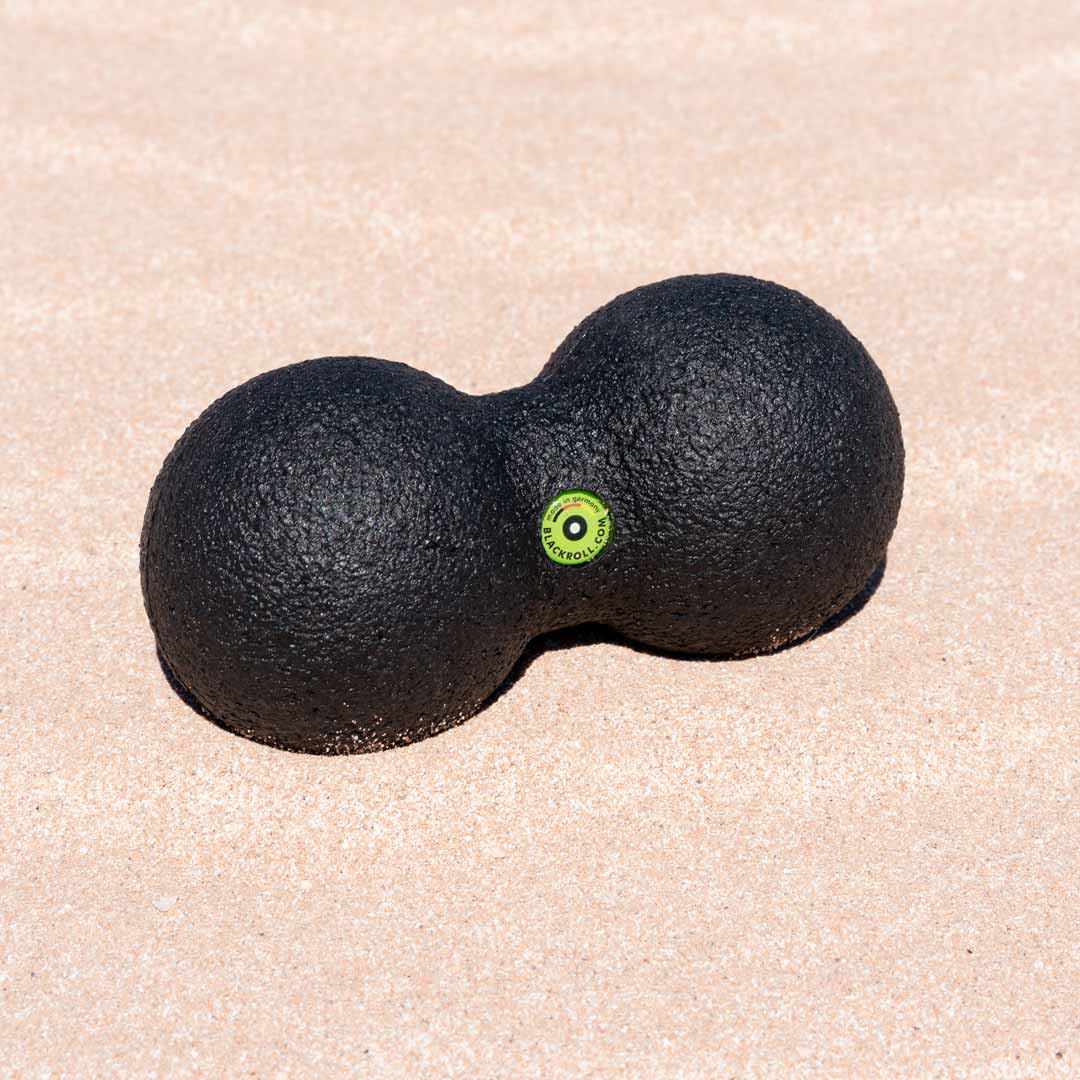 Blackroll peanut dual massage ball on the sand.