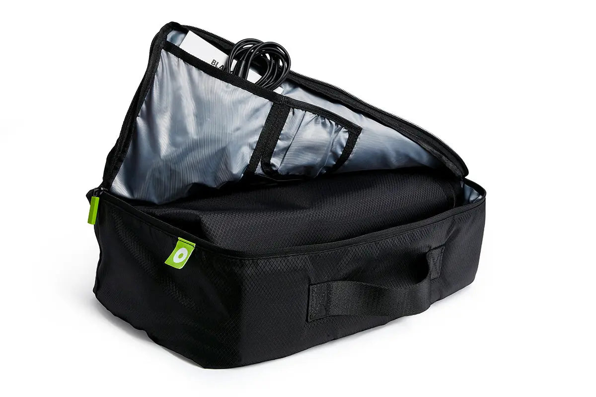Blackroll recovery boots inside bag which is half zipped, showing the power supply.