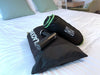 Blackroll recovery pillow rolled up and in its travel bag, fascia gun and a bag containing recovery boots 2.0.