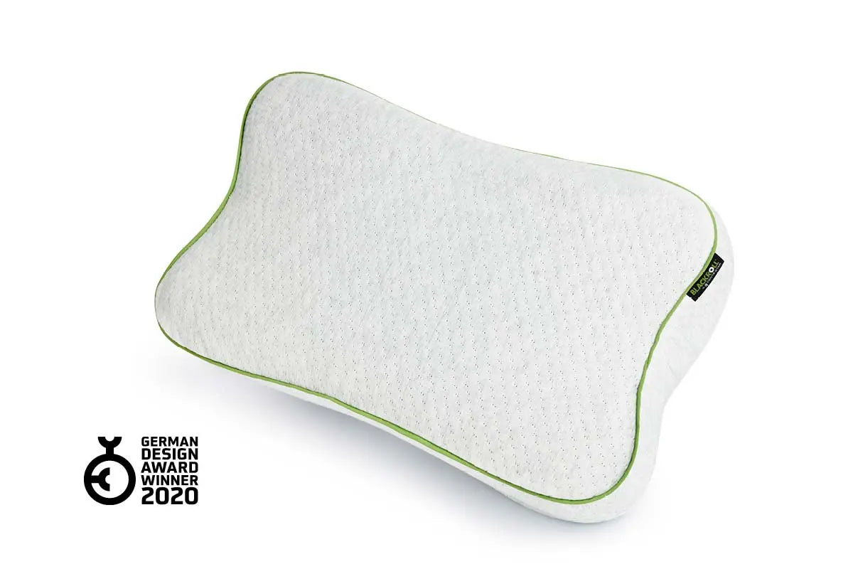 Front view of a blackroll recovery pillow showing the white material and green border, and a German design award winner badge.