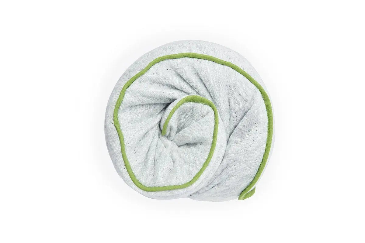 Blackroll recovery pillow - white with green border, shown rolled up into a small ball.