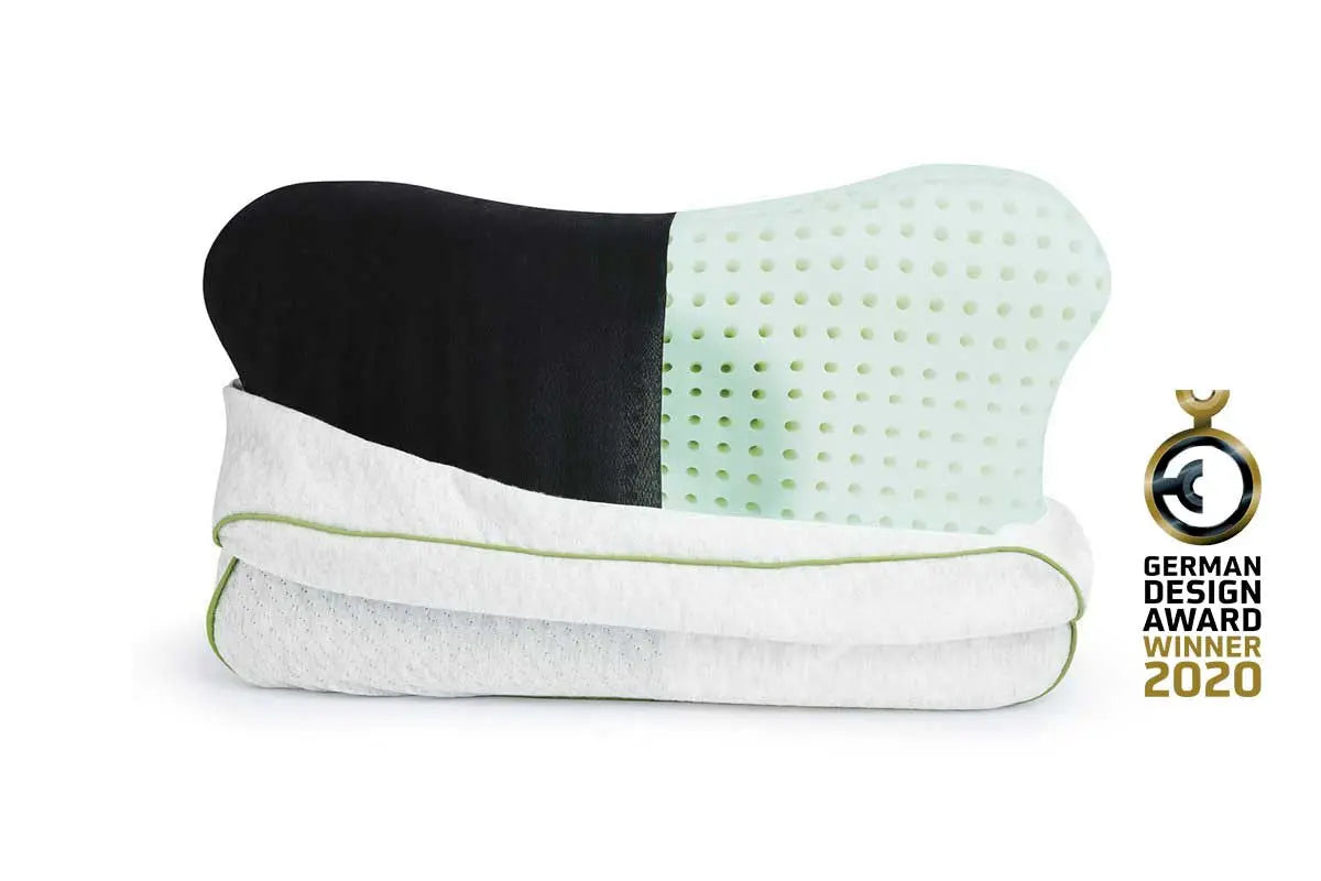 Partially unzipped Blackroll recovery pillow showing the foam and black cover as well as the white pillowcase with green border, featuring the German design award winner badge.