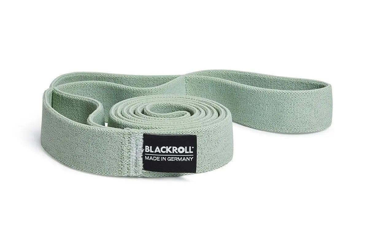 Green exercise resistance band with Blackroll logo on a white background.