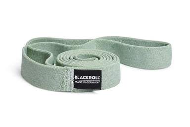 Green exercise resistance band with Blackroll logo on a white background.