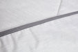 Close up of grey coloured Blackroll ultralite blanket showing grey border and white stitching.