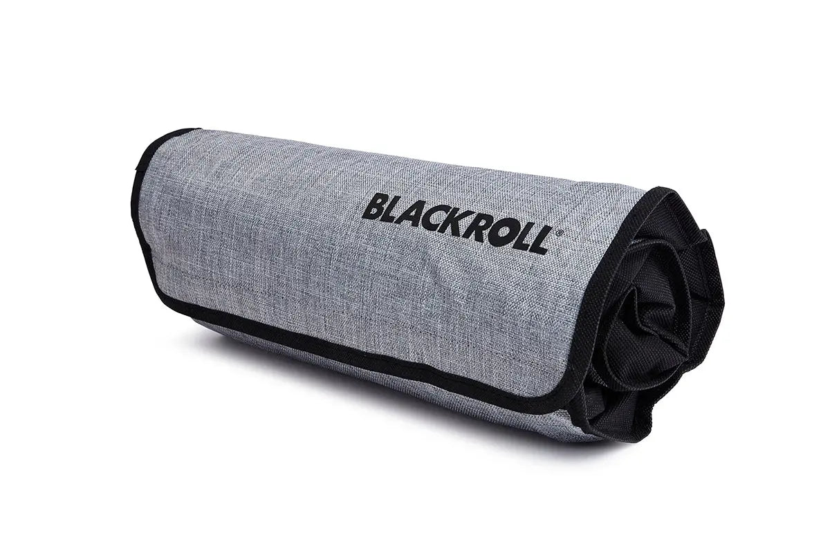 Blackroll ultralite blanket rolled inside grey travel bag.