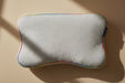 A kids size blackroll recovery memory foam pillow that is white with a rainbow border.