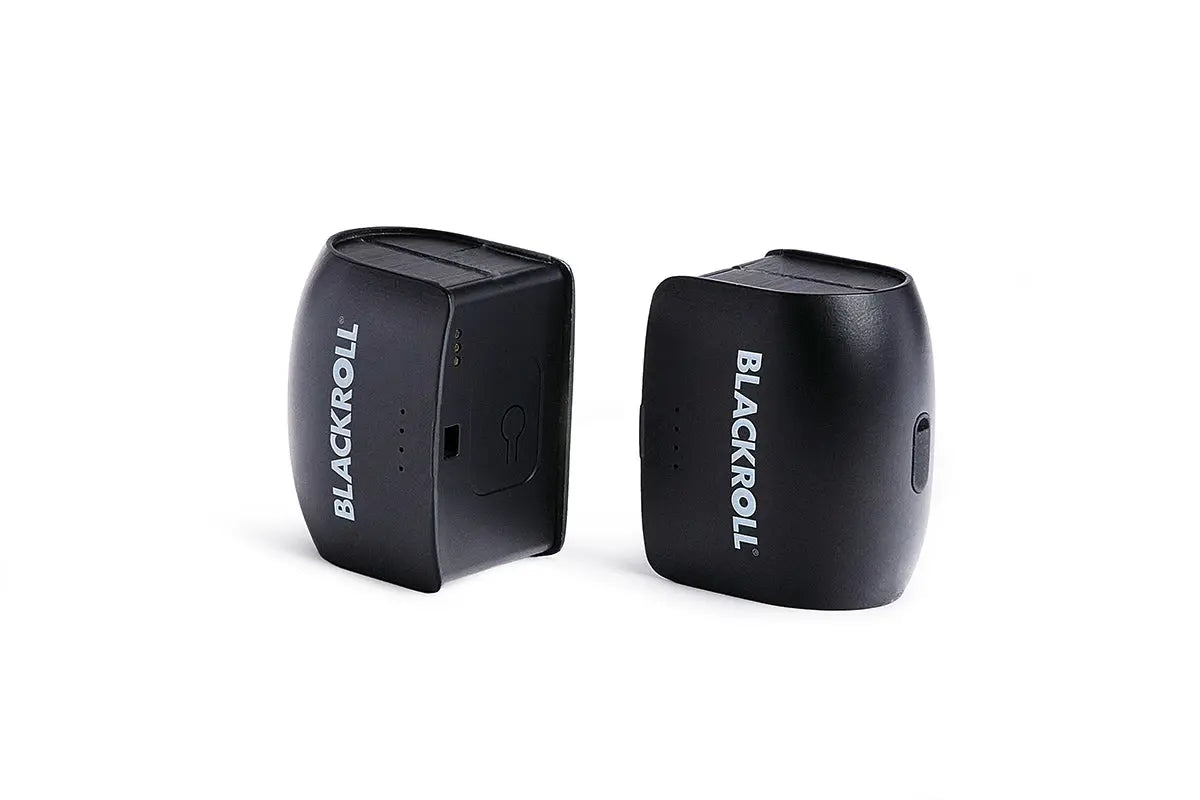 Close up side view of two black infinity batteries for the Blackroll recovery boots 2.0.