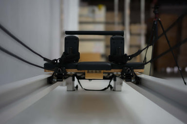 Close-up of a Queen reformer from inside the frame on a blurred background
