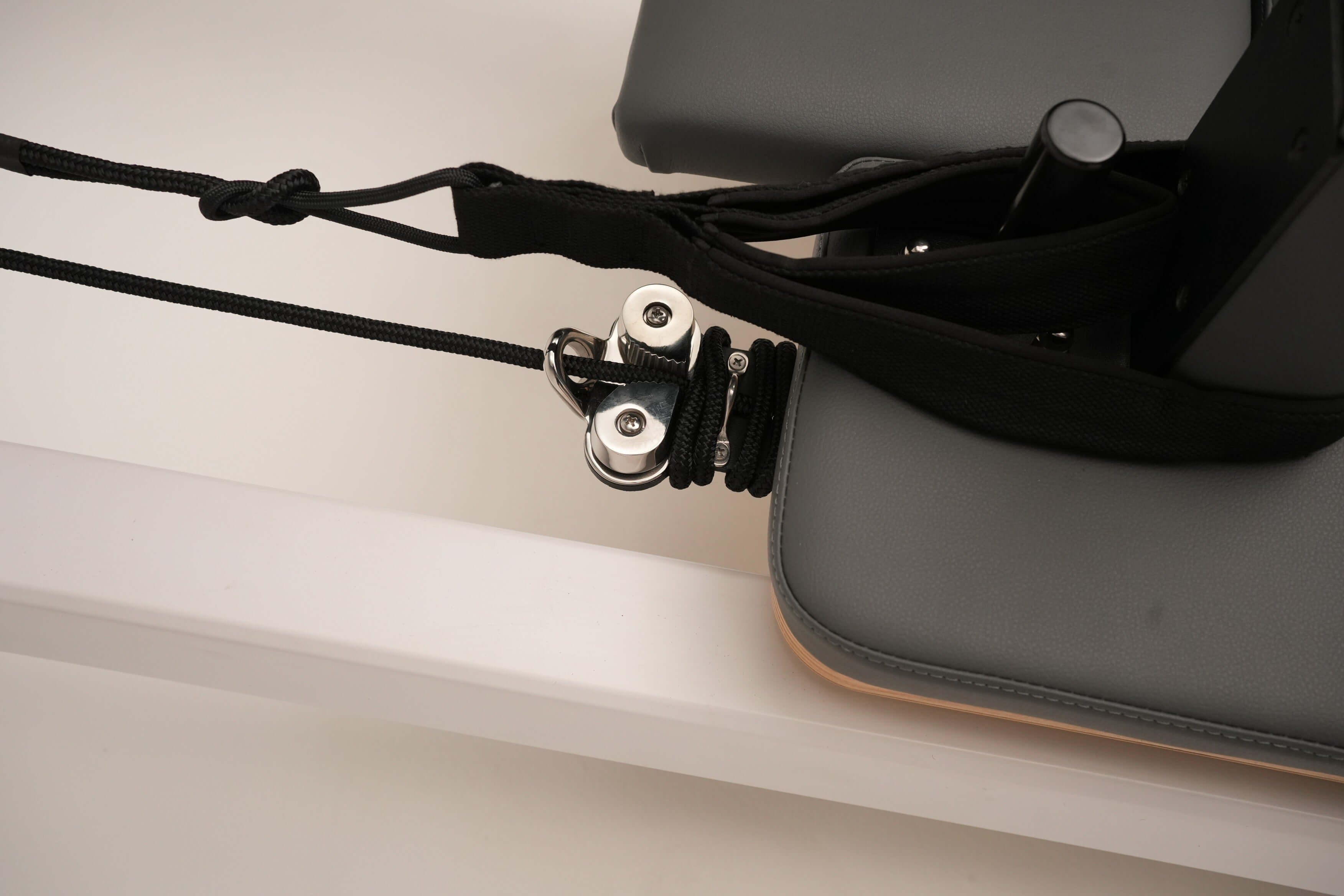 Close up of the straps on the Core Collab Queen Studio Pilates reformer, also showing the cleats.