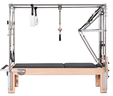 The Core Collab Eco Cadillac reformer showing the wooden frame and full trapeze on a white background.