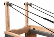 Close up end view of the Core Collab Eco Studio Full Track Pilates reformer showing the pulleys.