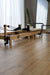 The Core Collab foldable eco Pilates reformer in a studio setting in front of a mirror.