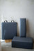The accessories included with the Core Collab Queen Studio Pilates reformer, showing the jumpboard, sitting box and platform cushion in charcoal.