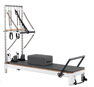 The Core Collab Queen reformer tower in white with charcoal upholstery on a white background.