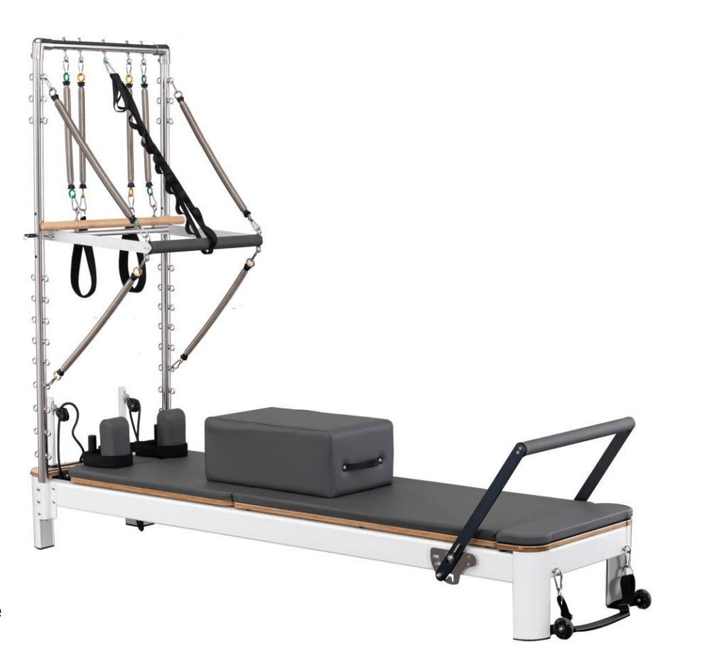 The Core Collab Queen reformer tower in white with charcoal upholstery on a white background.