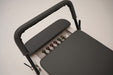 Close up of the Core Collab Queen Pilates reformer showing the footbar and 6-spring system of 3 reds, 2 greens and 1 yellow spring.
