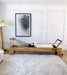 Core Collab Eco Warrior Pilates reformer showing beechwood frame and beige upholstery in a living room setting.