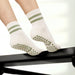 Elliosa Dual direction grip socks in matcha cream stripe worn by someone using a Pilates reformer.