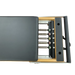Close up of a pilates reformer machine with black upholstery, showing 5 colour coded springs.