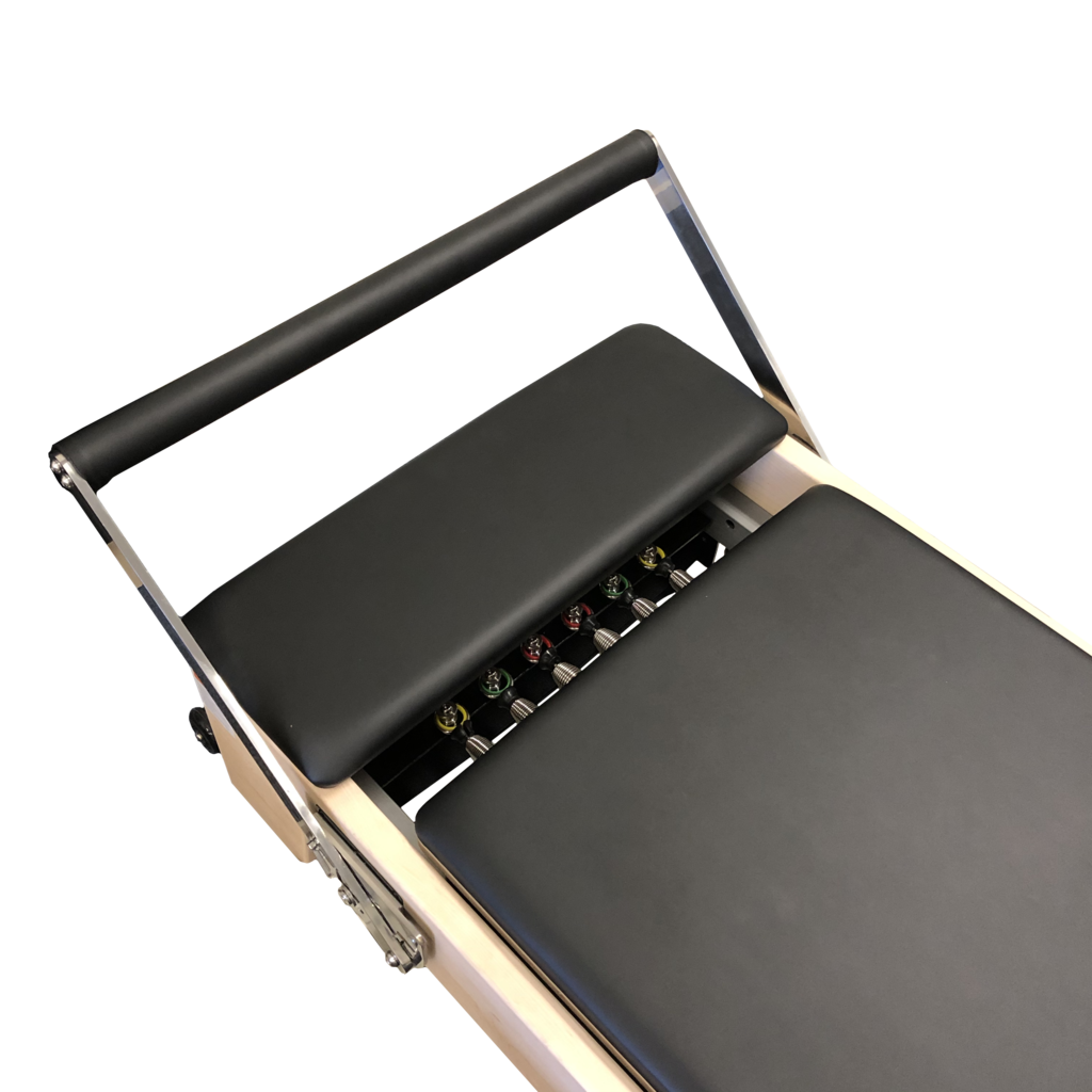 Close up of pilates reformer with black upholstery showing 6 colour coded springs and foot bar.