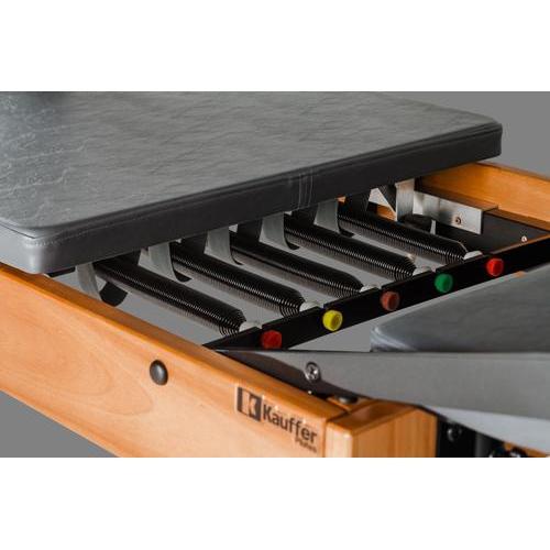 Close up of a reformer pilates bed showing 5 colour coded springs.