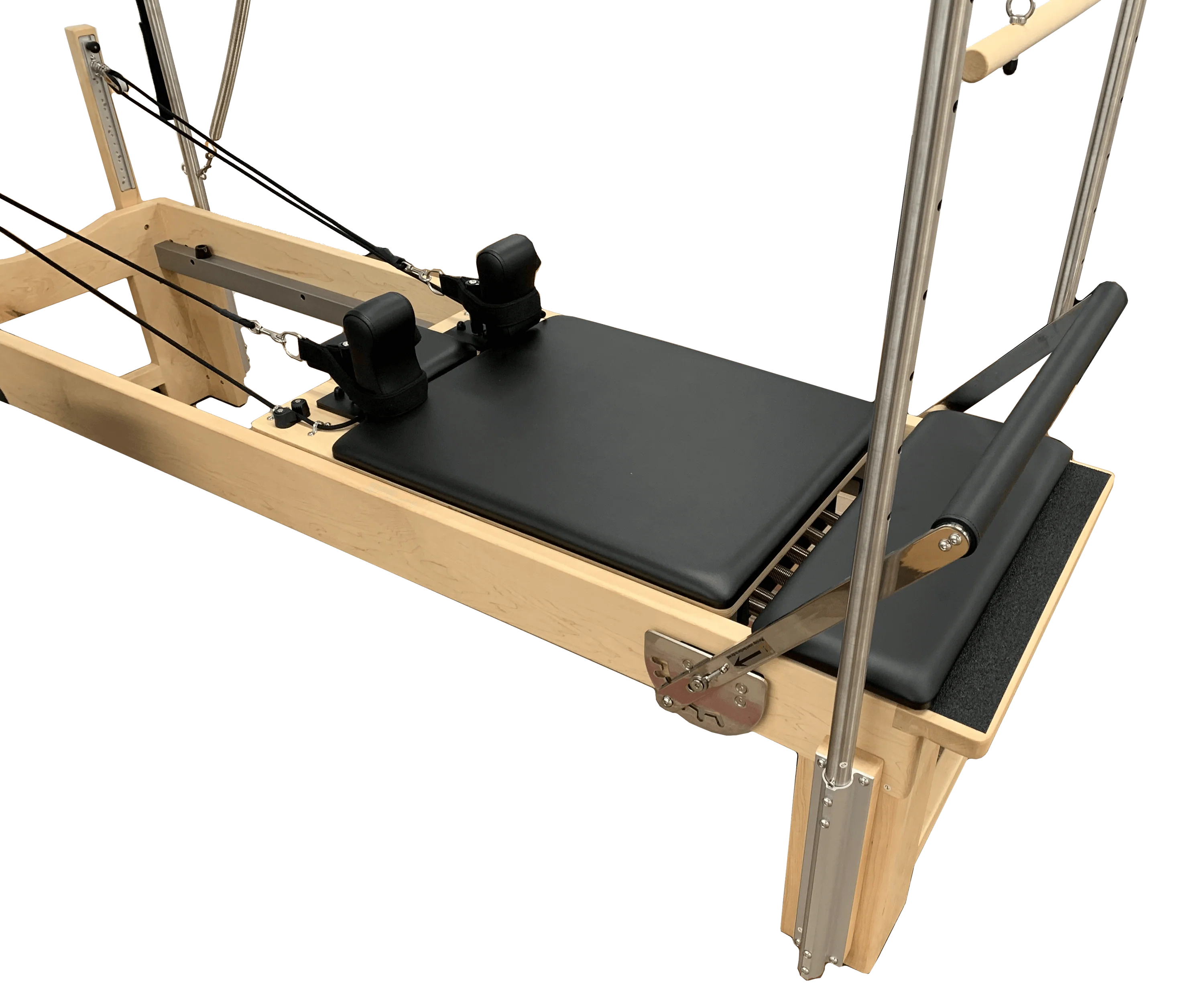 Close up of reformer bed with black upholstery and adjustable footbar and straps.