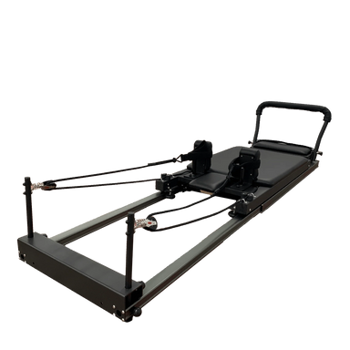 black pilates reformer showing ropes and footbar on a white background