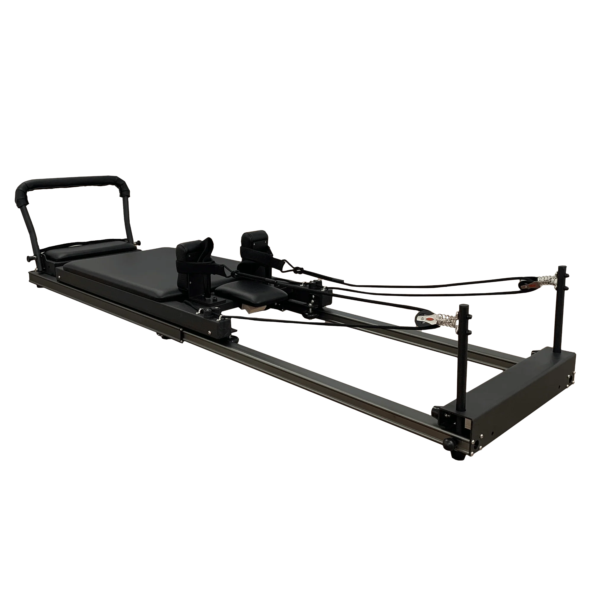 Black pilates reformer on an angle on a white background.