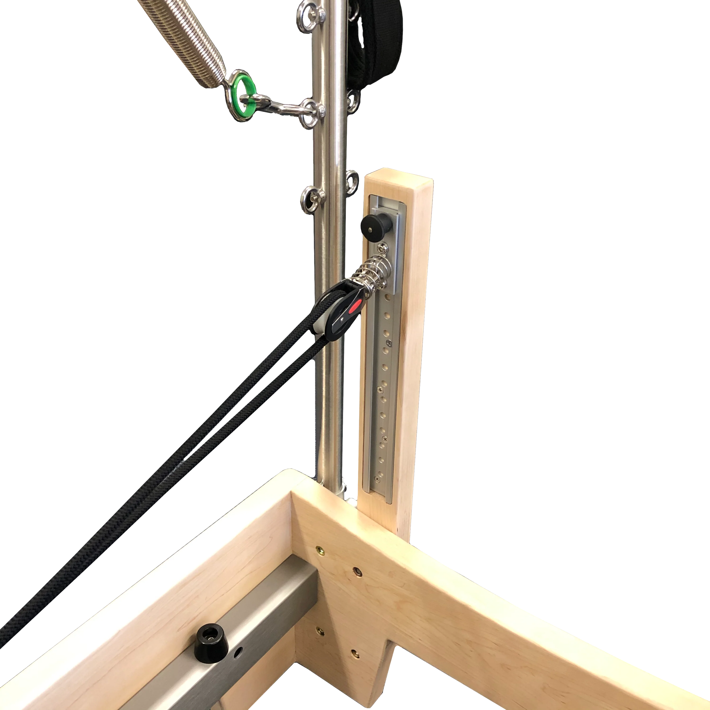 Close up of pilates reformer showing light wooden frame and metal trapeze attachment.