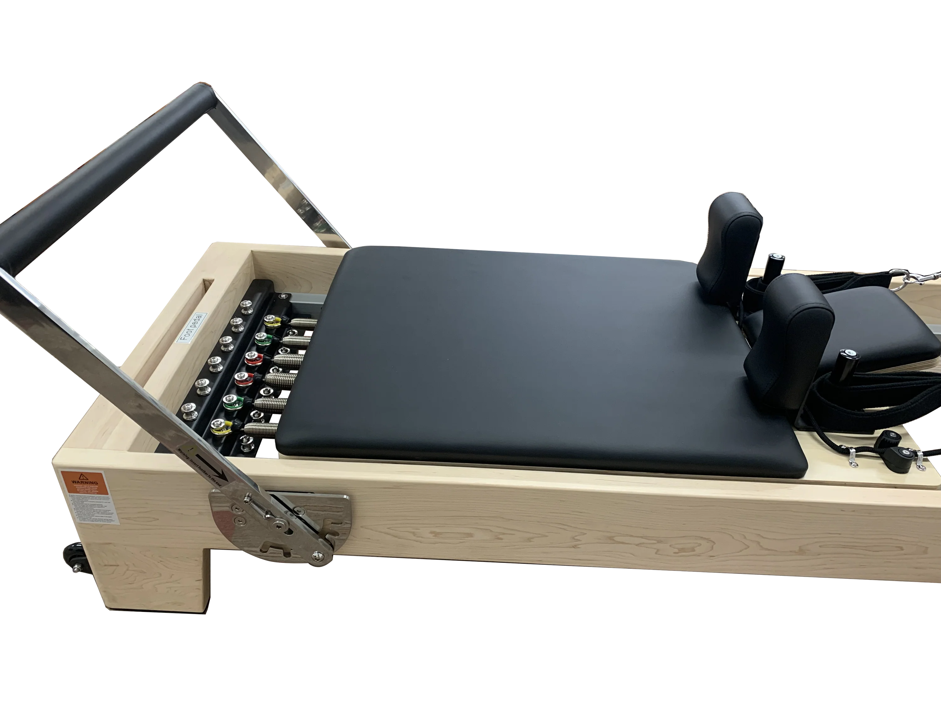 Close up of pilates reformer showing reformer bed, head and shoulder cushions and foot bar.