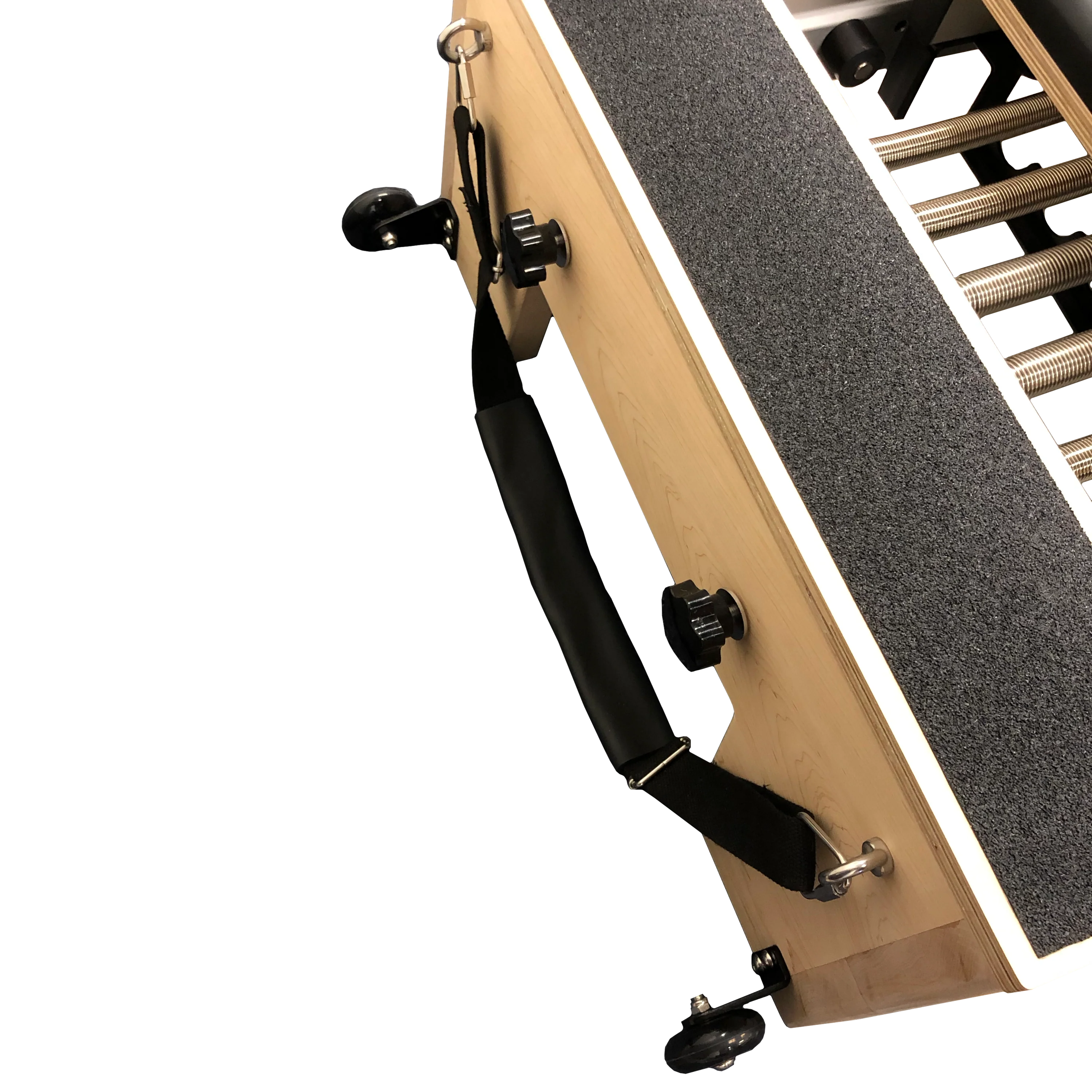 Close up of end of pilates reformer showing handle and wheels for moving.