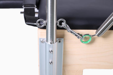 Close-up of a metal bracket attached to the wooden surface of a cadillac table with a green tag.