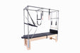 Clinical Pilates cadillac table made of Canadian Maple wood with full trapeze and attachments, with black upholstery.