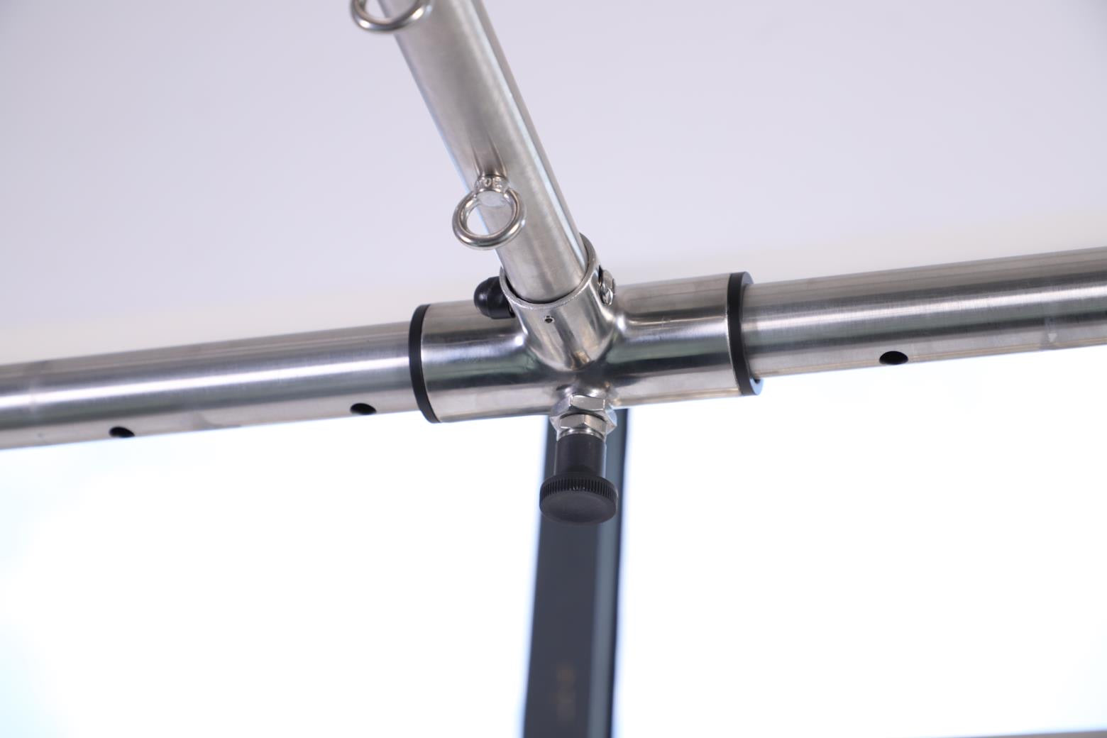 Close up of metallic crossbar of cadillac frame on a white background.