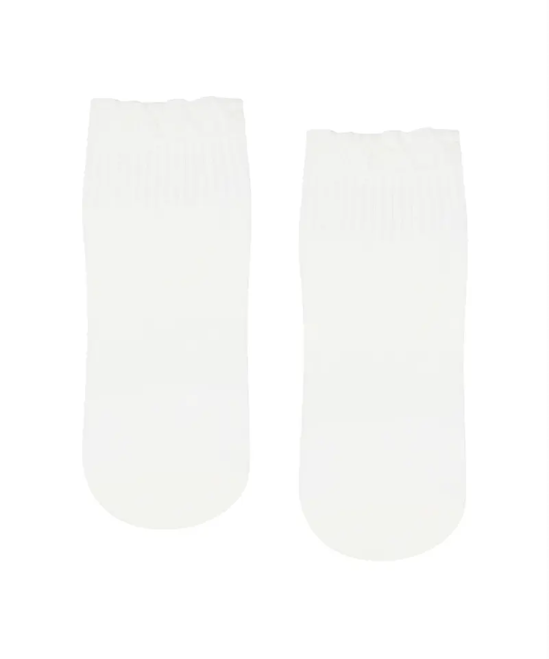 Pair of white quarter crew socks with ruffle at top, in white background.