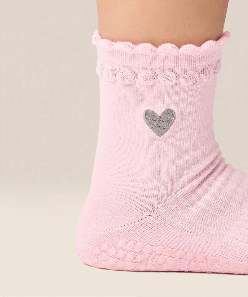 Close up side view of moveactive crew grip socks in heart ruffle pink.