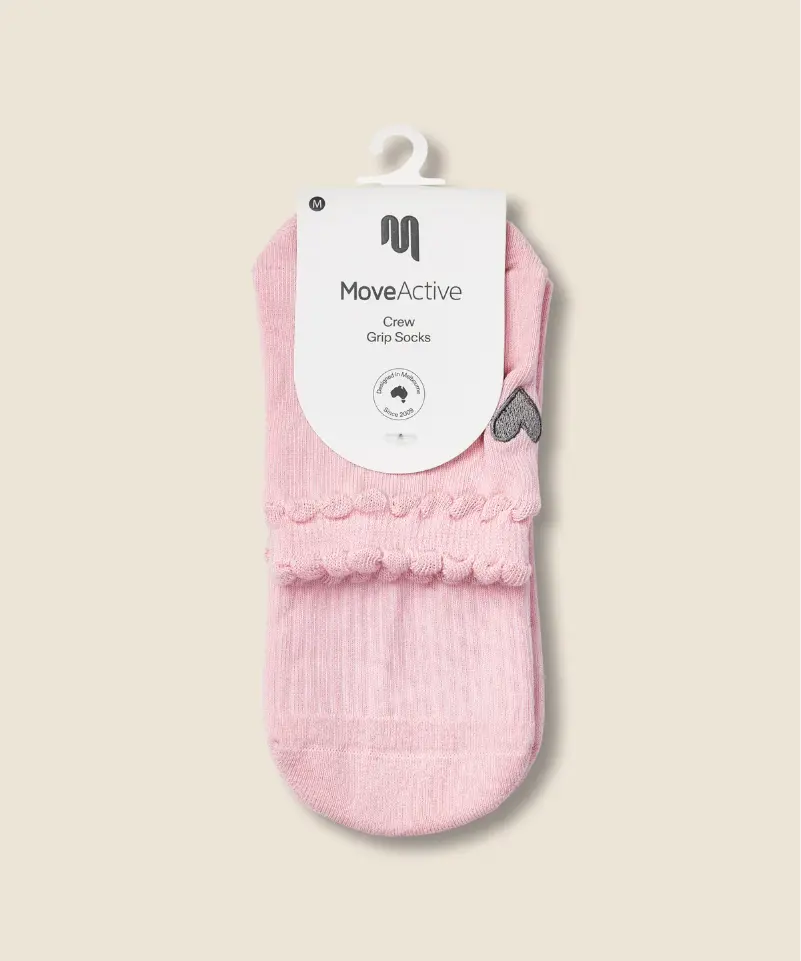 top view of MoveActive crew grip socks in packet in heart ruffle pink colour.