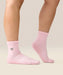 Side view of moveactive crew grip socks in heart ruffle pink.
