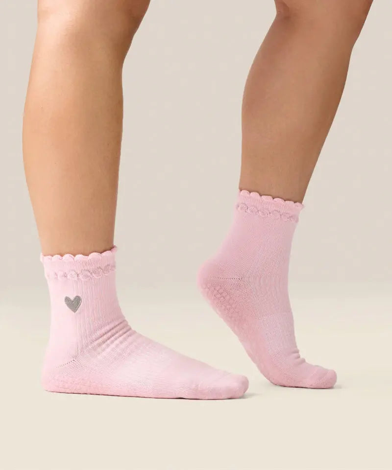Side view of moveactive crew grip socks in heart ruffle pink.