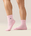 Side view of moveactive crew grip socks in pink heart ruffle.