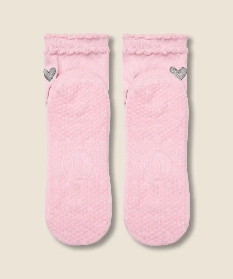 sole view of moveactive crew grip socks in pink ruffle, with grips and logo visible.